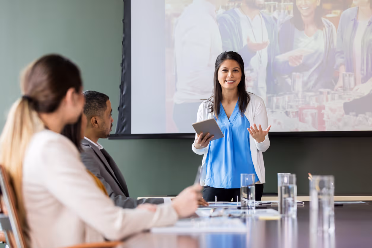 Nonprofit manager on a meeting with two of his team in his office.