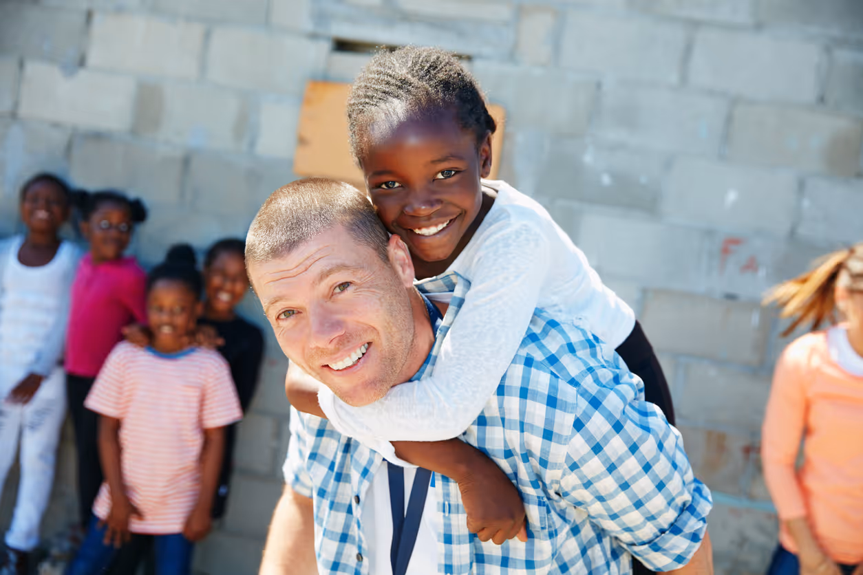 Nonprofit manager on a meeting with two of his team in his office.