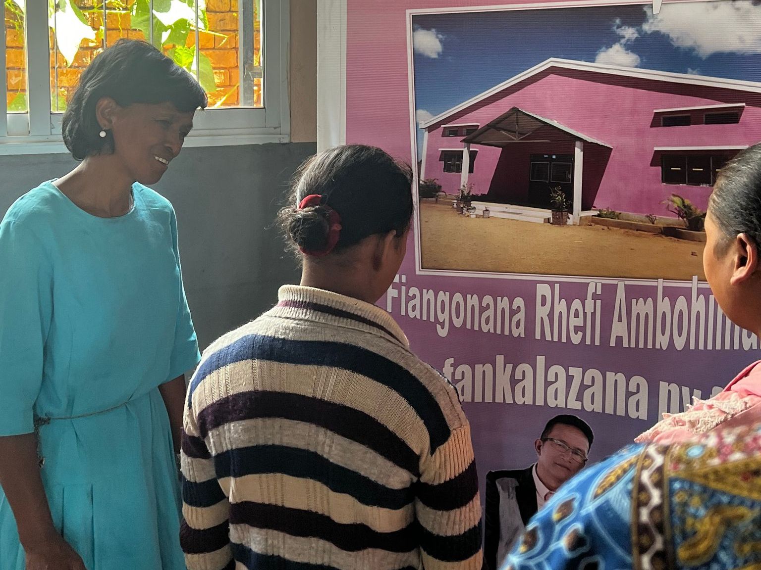 The elderly lady being able to see the shapes of the letters and see the church's poster