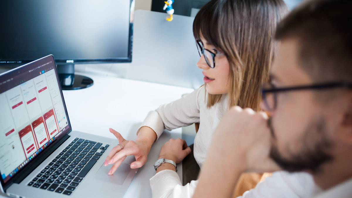 Two professionals reviewing their website before going live.