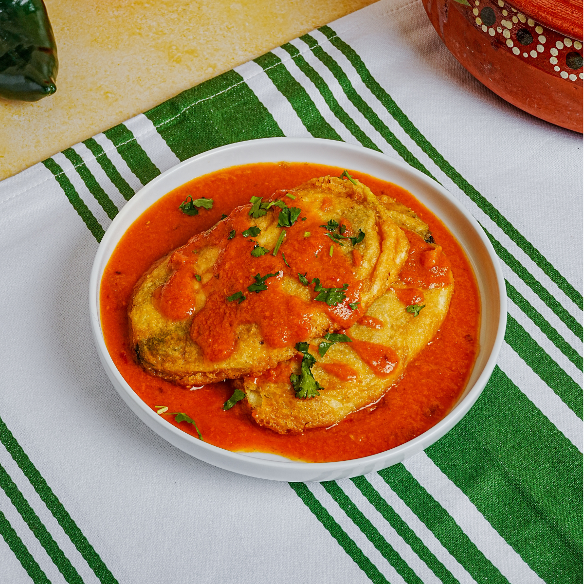 Image of wrapped Pupusas in a tray