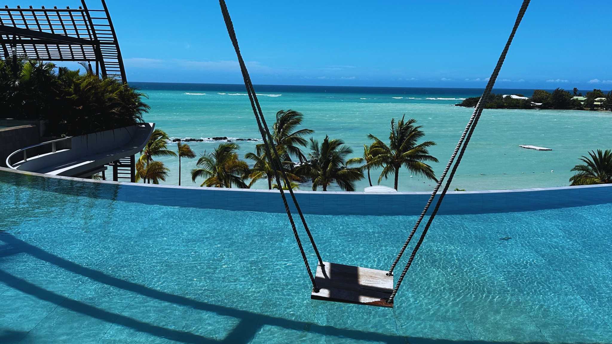Rooftop infinity pool at Bisou, LUX* Grand Baie Mauritius with panoramic sea views.
