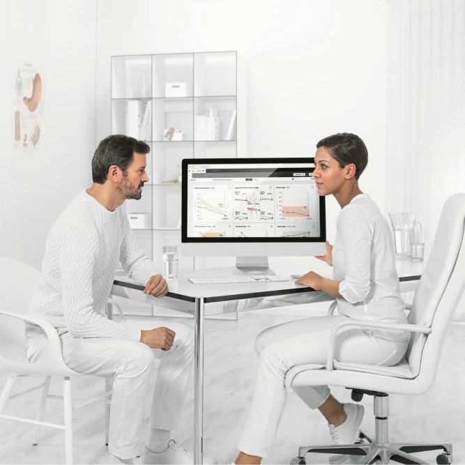 Two doctors consulting about a computer screen