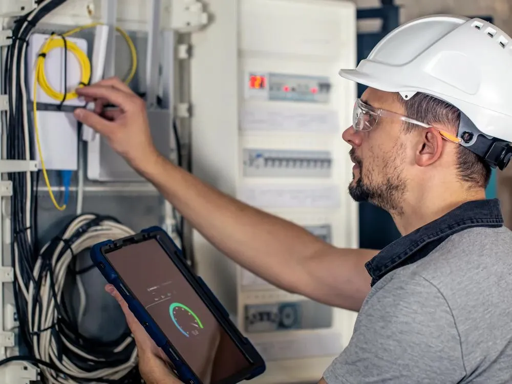 Engineer inspecting an electrical distribution board