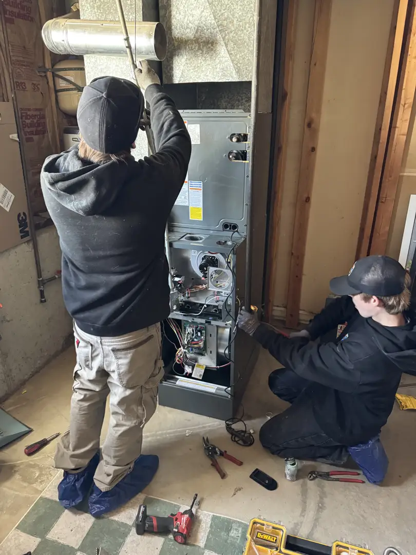 Professional HVAC technicians installing a new energy-efficient AC system - ac installation in centerville ut Professional HVAC technicians installing a new energy-efficient AC system - ac installation in centerville ut