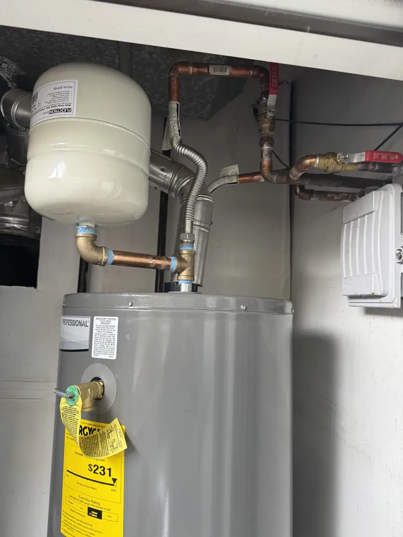 Homeowner reaching for a main water shutoff valve in a utility room - emergency pipe repair in layton, ut