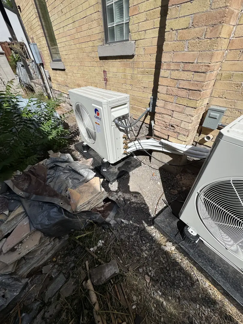 Multi-zone outdoor condenser unit sitting on a concrete pad outside a clean residential home - adding cooling without Multi-zone outdoor condenser unit sitting on a concrete pad outside a clean residential home - adding cooling without