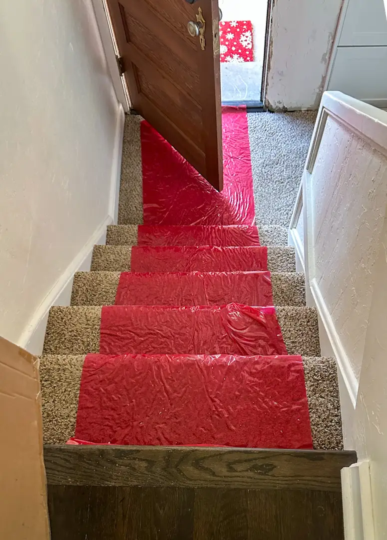 technician putting on blue shoe covers before stepping onto a homeowner's carpet - advantages of a company that treats your technician putting on blue shoe covers before stepping onto a homeowner's carpet - advantages of a company that treats your