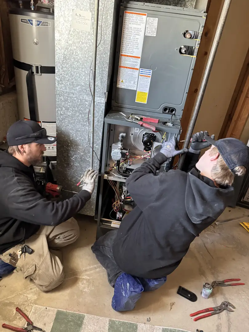 technician explaining the internal components of an indoor air handler unit to a homeowner technician explaining the internal components of an indoor air handler unit to a homeowner