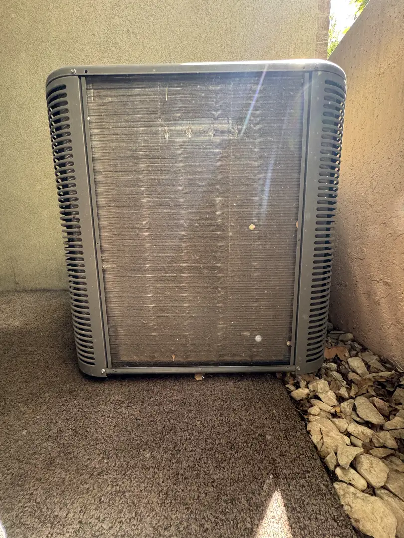 An outdoor condenser unit in a dusty yard with dry grass and summer heat haze - how long does an ac unit last An outdoor condenser unit in a dusty yard with dry grass and summer heat haze - how long does an ac unit last