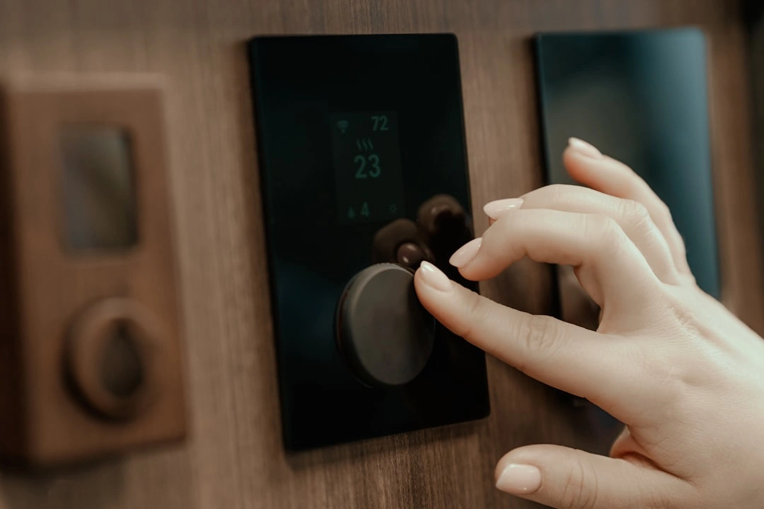 homeowner adjusting a smart thermostat via a smartphone app - how advanced ac technology improves your home comfort homeowner adjusting a smart thermostat via a smartphone app - how advanced ac technology improves your home comfort