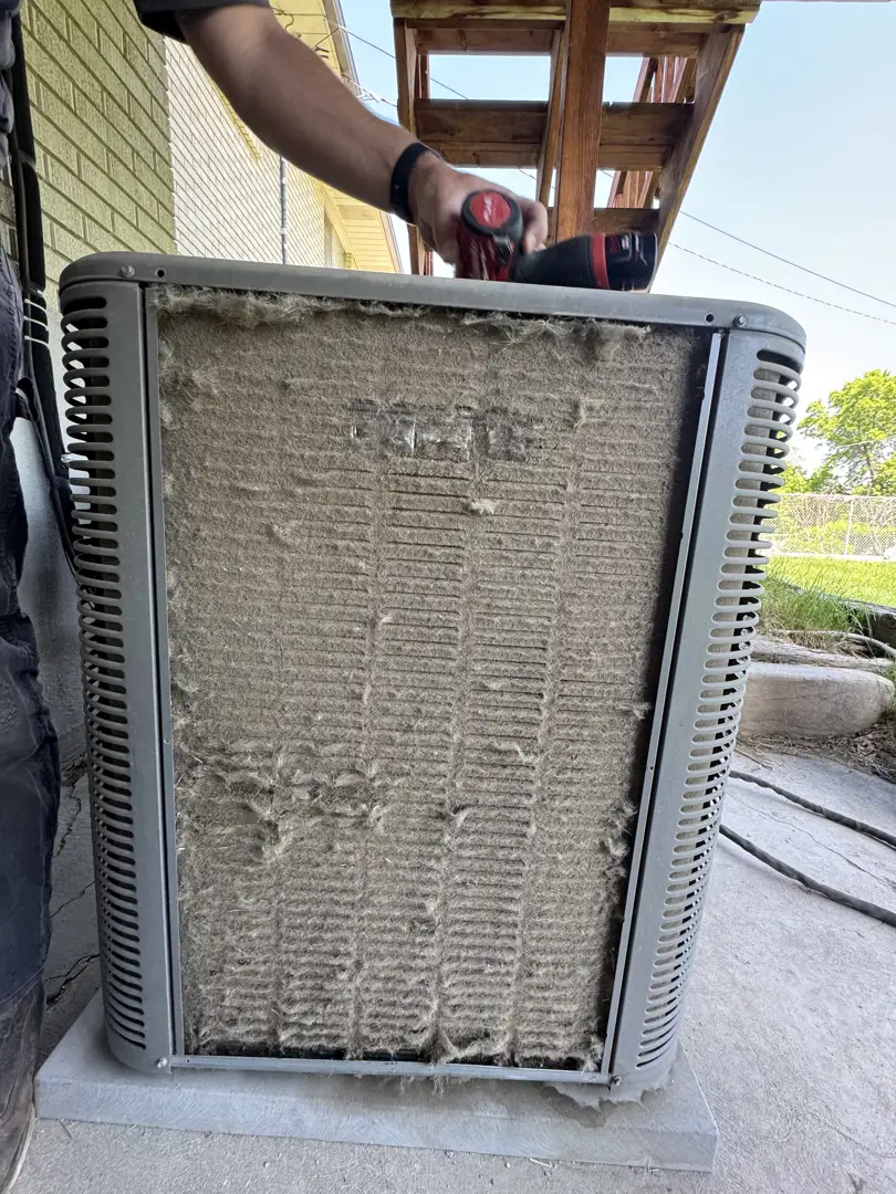 Comparison of a clean condenser coil versus a dirty, debris-clogged coil - how spring prep prevents expensive summer