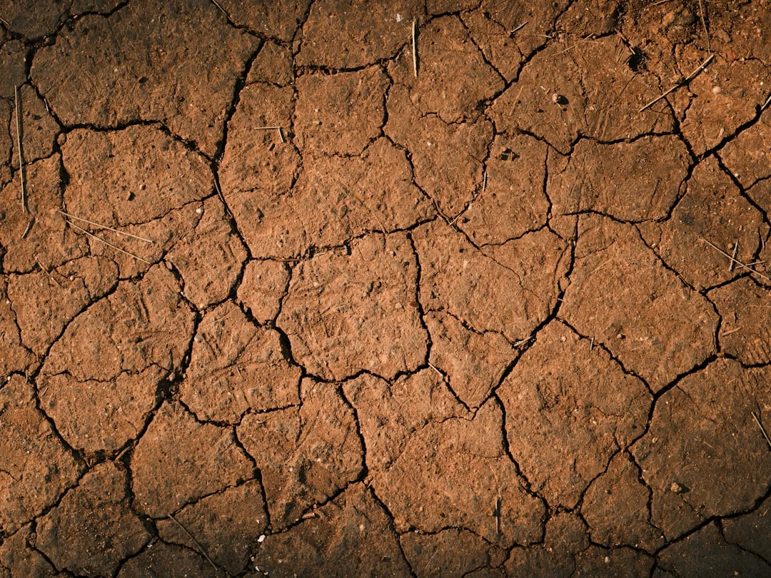 dry cracked desert soil transitioning to a winter landscape dry cracked desert soil transitioning to a winter landscape