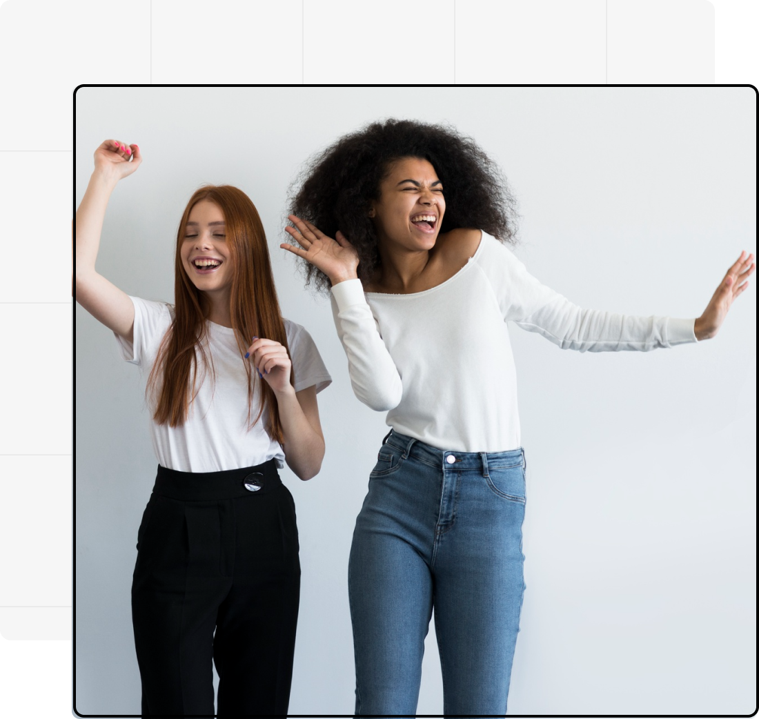 Young woman and man having a casual conversation at a desk with notebooks, phone, and glass of water, representing teamwork or creative discussion.