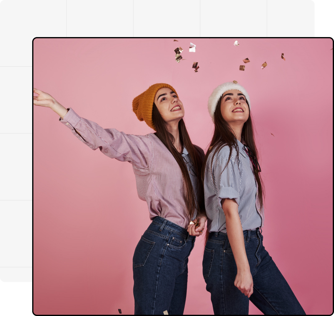 Young woman and man having a casual conversation at a desk with notebooks, phone, and glass of water, representing teamwork or creative discussion.