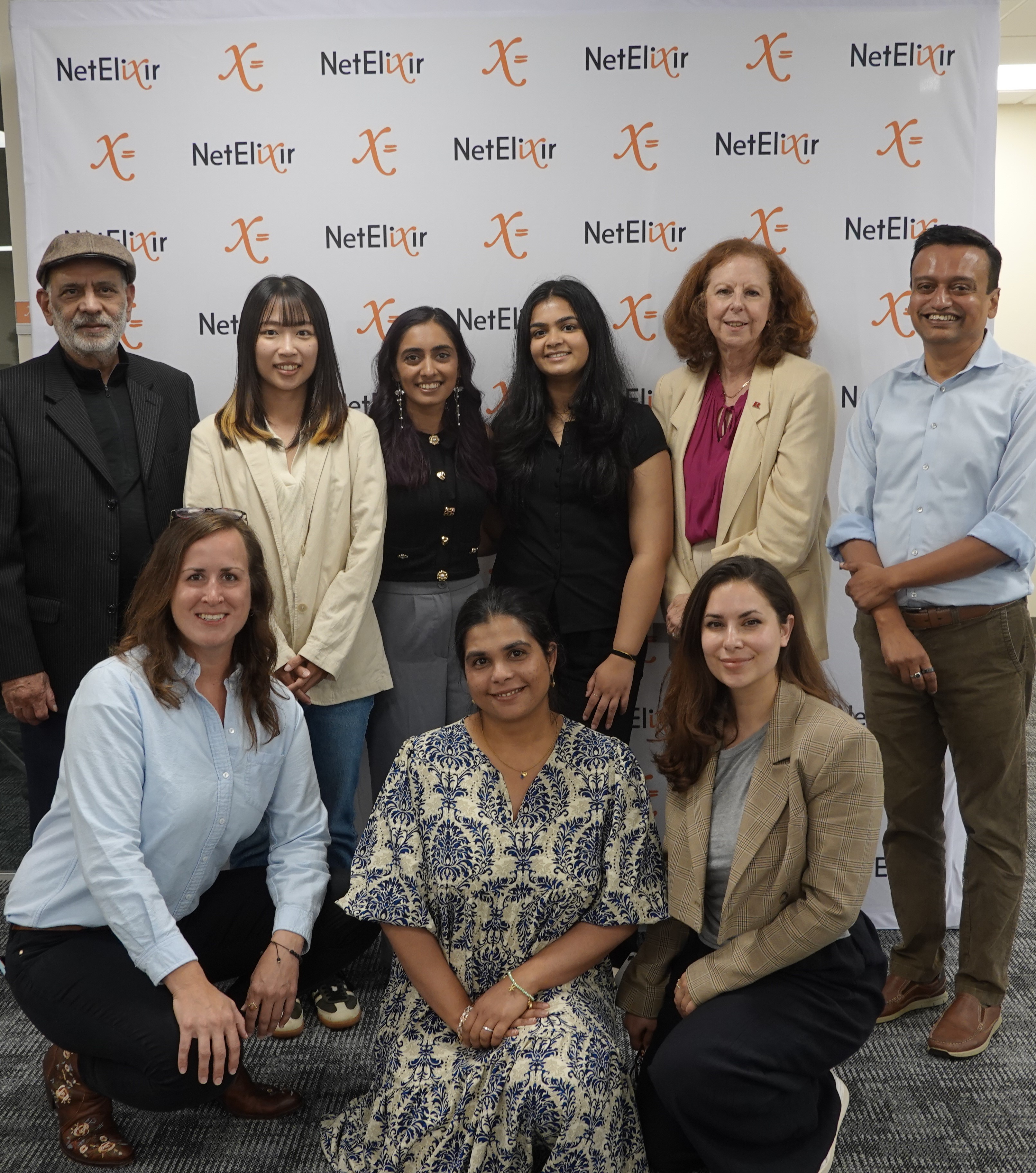 Rutgers MBS externship students with the NetElixir team in front of the NetElixir backdrop