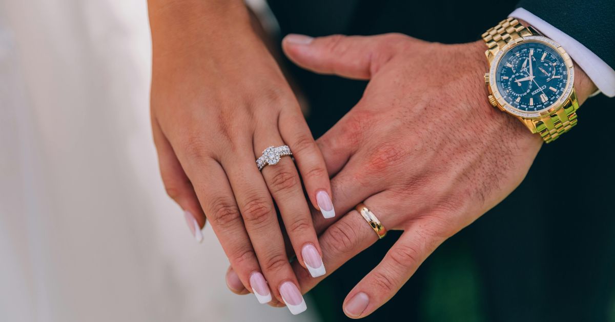 Couple holding hands wearing wedding rings symbolizing safe and secure diamond ring selling process