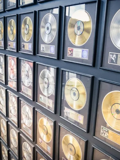 A collection of music awards comprising silver gold and platinum discs