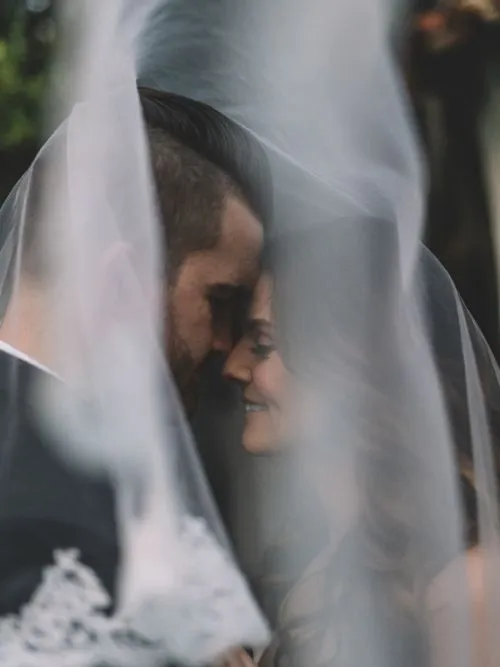 Couple facing each other at the altar in front of the priest during their wedding ceremony
