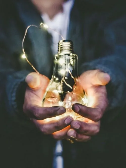 Fundraiser holding up a light of hope as part of a charity fundraising photo shoot