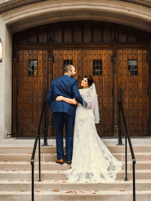 A couple posing for a photo outside the town hall before their civil wedding ceremony