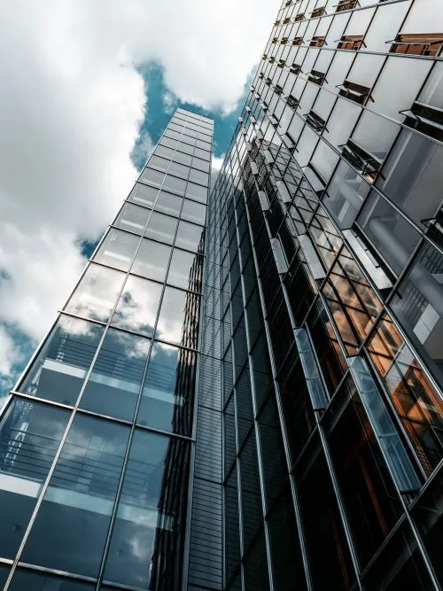 Shot of clouds passing over a tall glass office building for a commercial video shoot