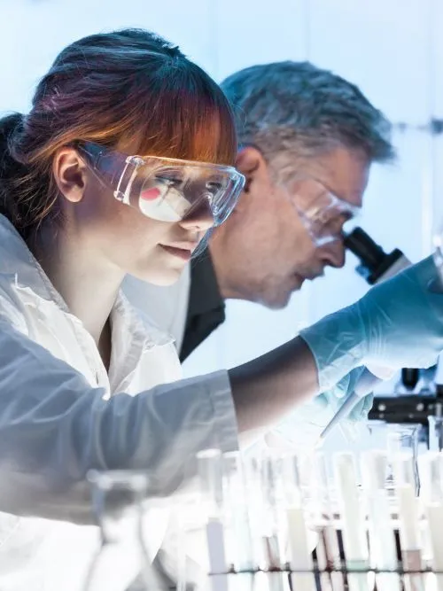 Documentary filming of two scientists in a laboratory working on new medical developments