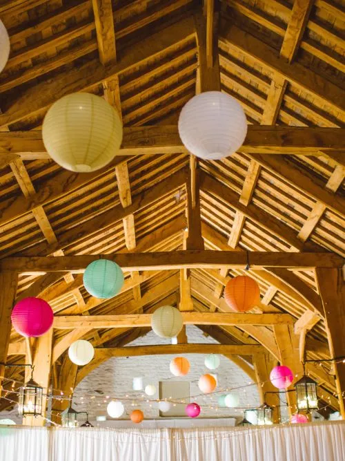 A function room decorated with balloons on the ceiling ready for a party