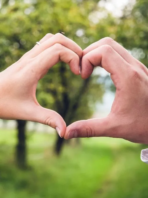 Creative photograph of a loveheart created from the hands of a couple on a pre-wedding shoot
