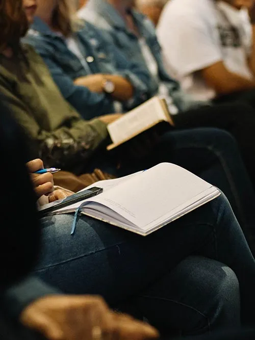 Audience taking notes duration a talk