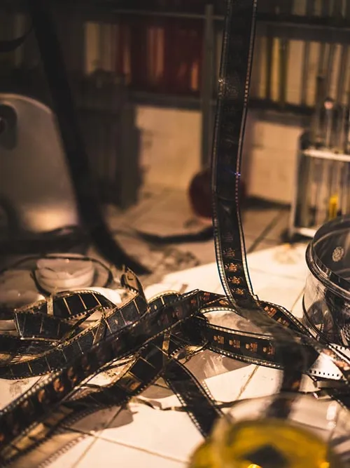 Old film reels with video cassettes in the background