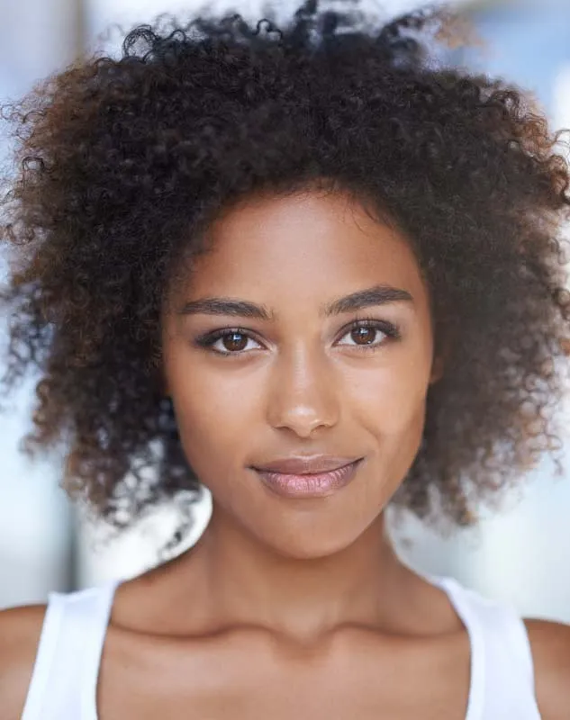 Attractive young black woman posing as a model in front of a camera
