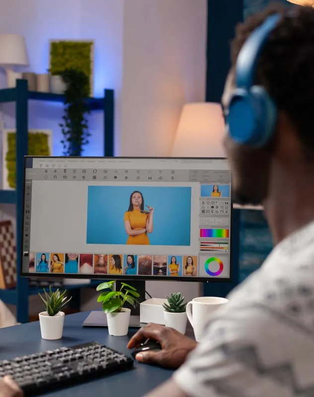 View of the shoulder of an editor reviewing social media content on a computer