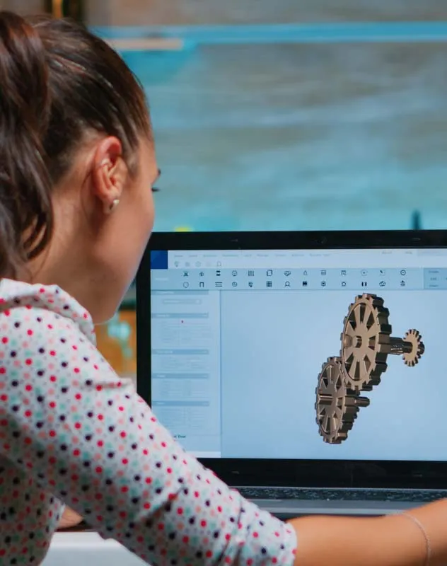 Editor sat at a desk working on a motion graphics project on a computer