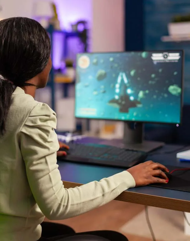 A female editor sat at desk working on an animation project on her computer