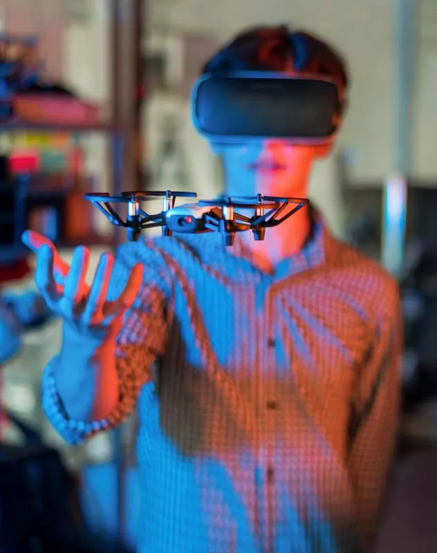 A fpv drone pilot wearing a VR headset and controlling the camera