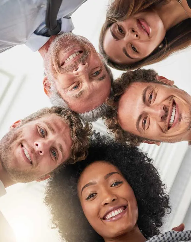 A group of talented professionals looking down into a camera
