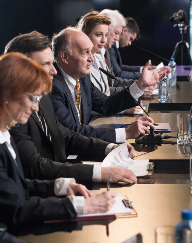 A panel of professionals sat together addressing an audience