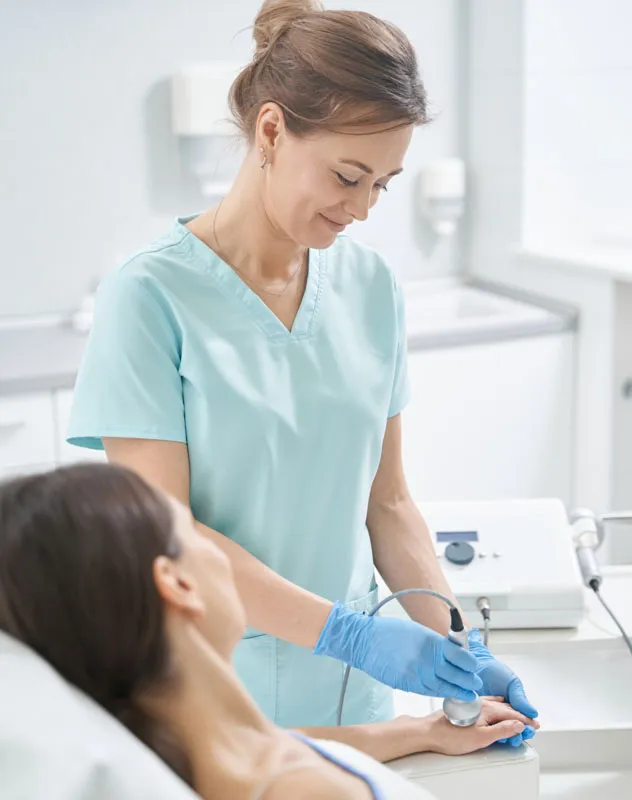 A nurse performing a procedure on a patient in the clinic