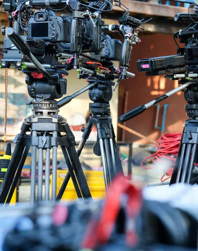 Several livestream cameras on tripods with transmitters and battery packs
