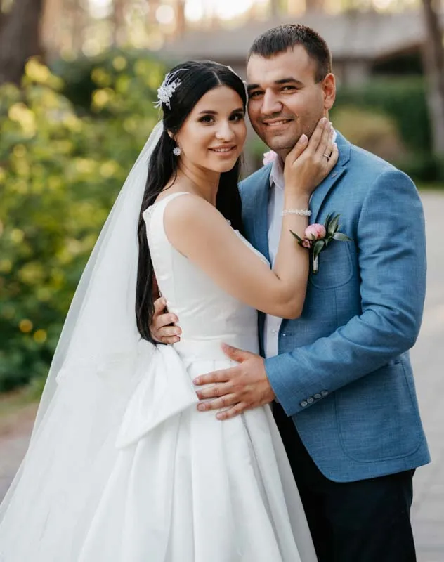 A Greek looking couple embracing in a pose for their wedding photographer