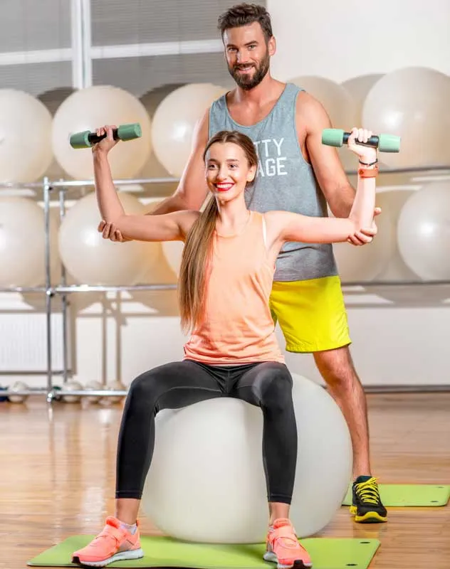 A fitness training helping his client with a weight control exercise