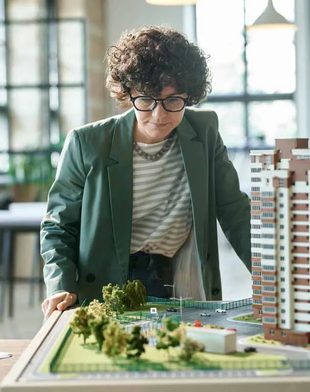 A woman looking at a model of a property investment project