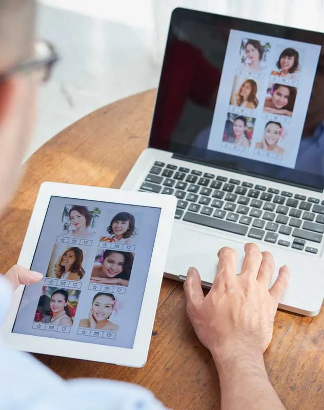 A man at a computer selecting images for a slideshow reel