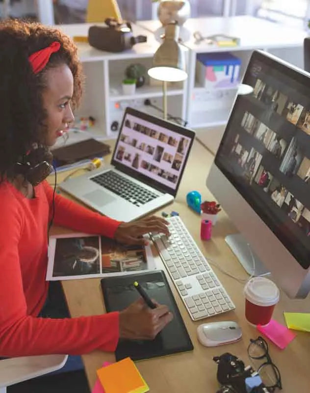 A female editor in a studio curating footage to edit for a reel