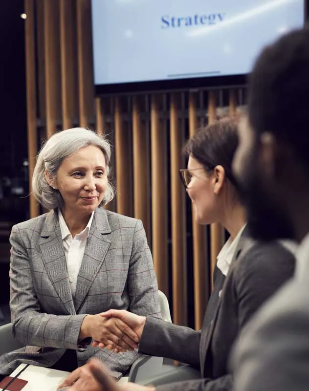 Three smart looking executives chatting together at a conference 