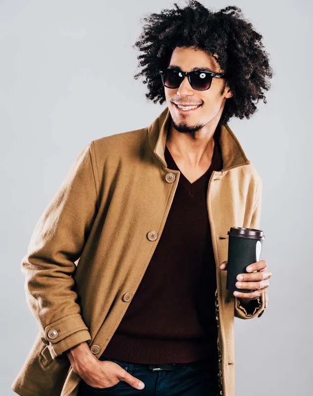 A male model in trendy dress posing for a fashion shoot