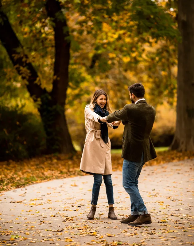 Couple in the woods celebrating their secret marriage proposal