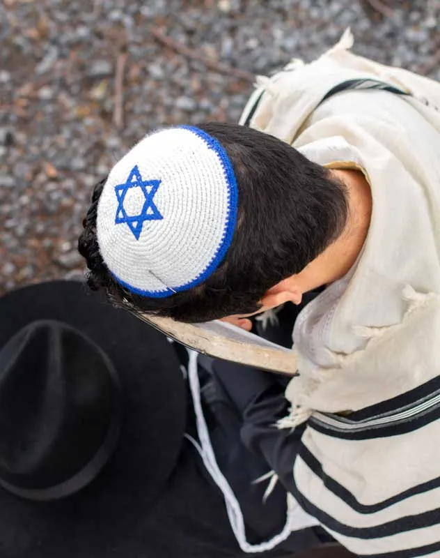 A thirteen year old Jewish boy reading from the Torah on his barmitzvah