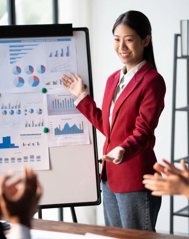 Young woman conducting a presentation to a group of professionals